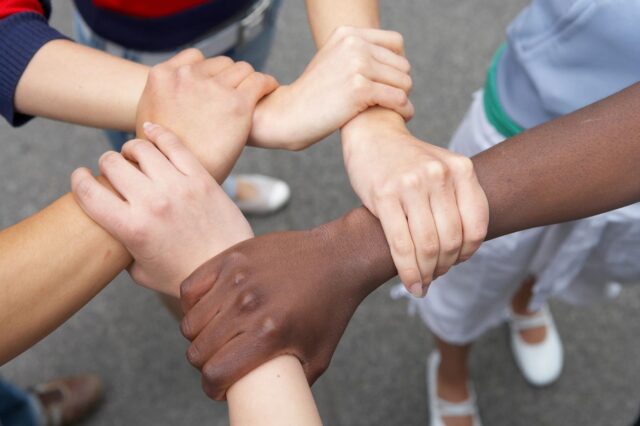 People holding wrists of one another