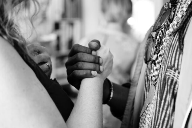 Two people in hand grab with each other representing conflict identity