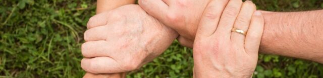 family holding wrists of each other representing conflict resolution