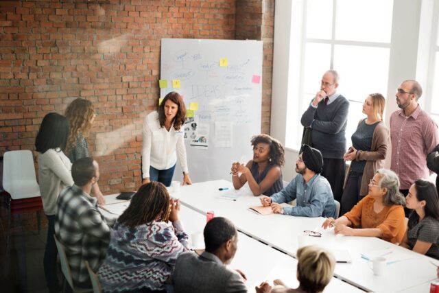 Group of diverse people in a meeting talking about racial composition in the workplace