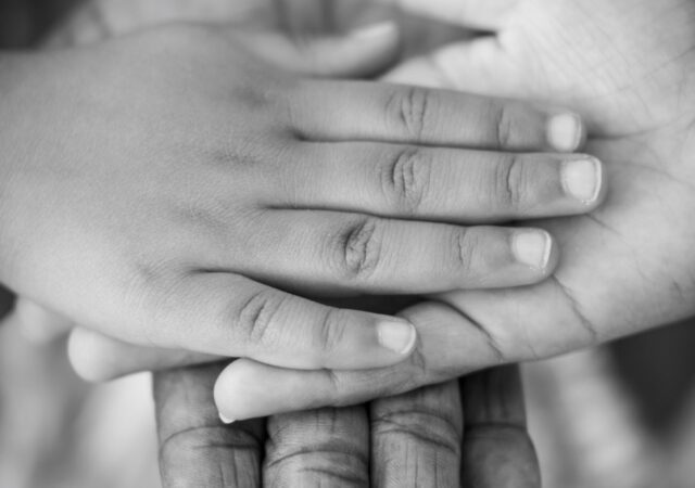 Hands resting on top of one another representing human rights and peace