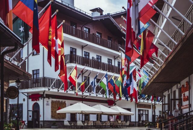 European building with hanging international flags symbolizing international affairs