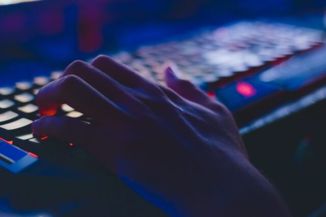 Person typing on computer keyboard at Florida-based tech company