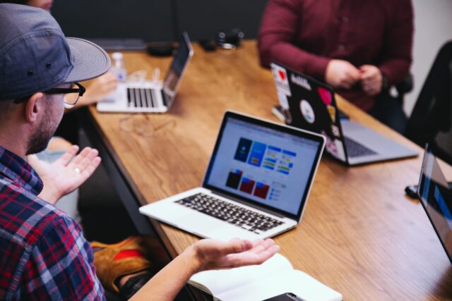 Man raising hands in Workplace team with intrateam conflict