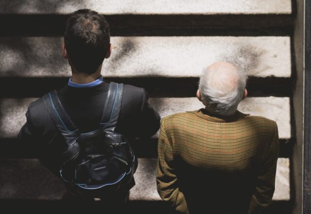 Older man and younger man walking to work symbolizing generational differences