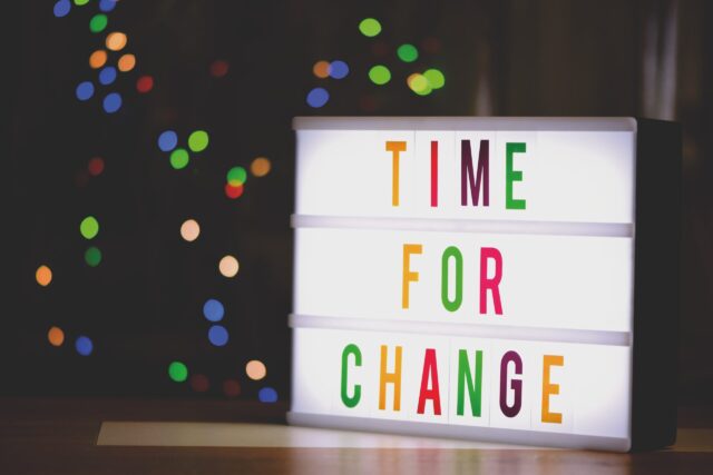 Lit 'Time for Change' sign that represents social change following conflict