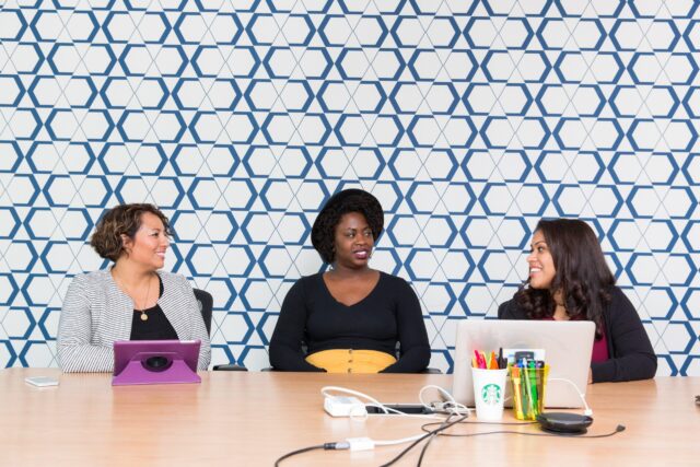 Three women talking about conflict at table