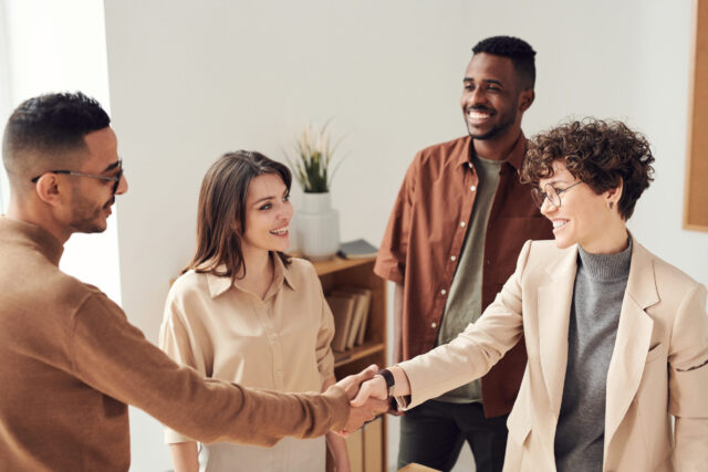 Two people shaking hands symbolizing conflict resolution and peace