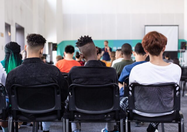 three employees in classroom setting at diversity training