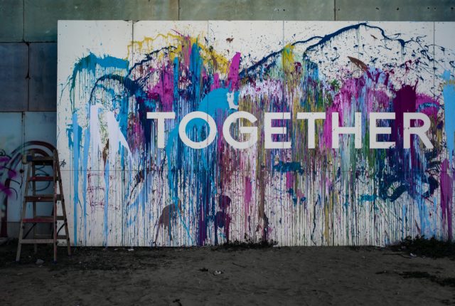 A wall that says "together" - the opposite of prejudice