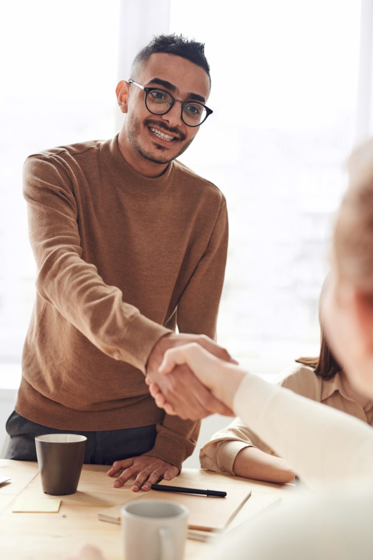 Colleagues Greeting After a Workplace Discussion Two colleagues shaking hands after a workplace discussion