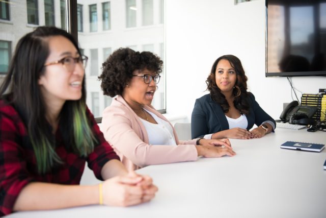 3 employees meeting about personality conflicts in the workplace