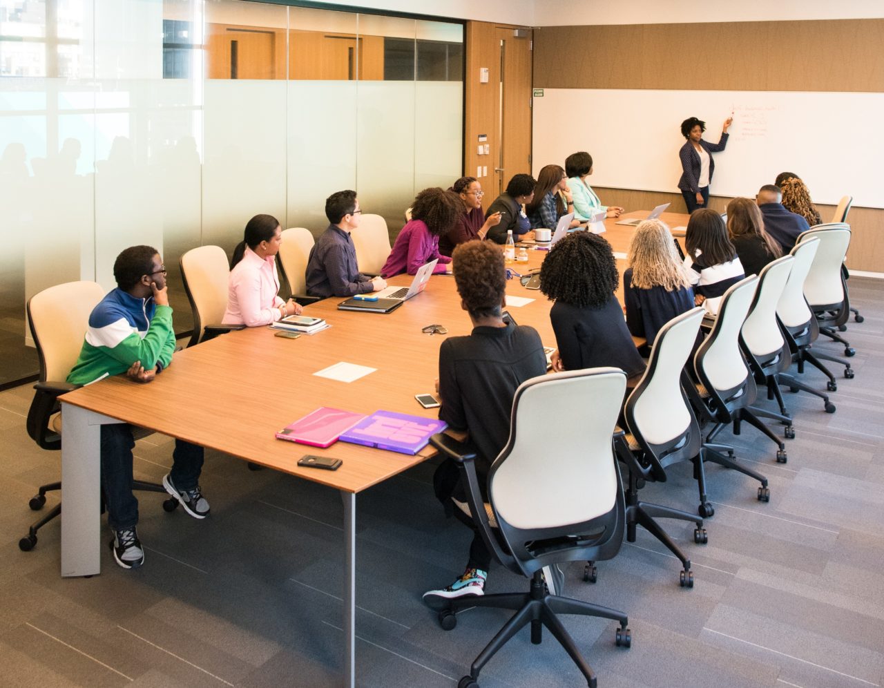 Employees participating in workplace communication training around a conference table
