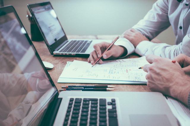 Two people in an office setting collaborating in a meeting on organizational performance