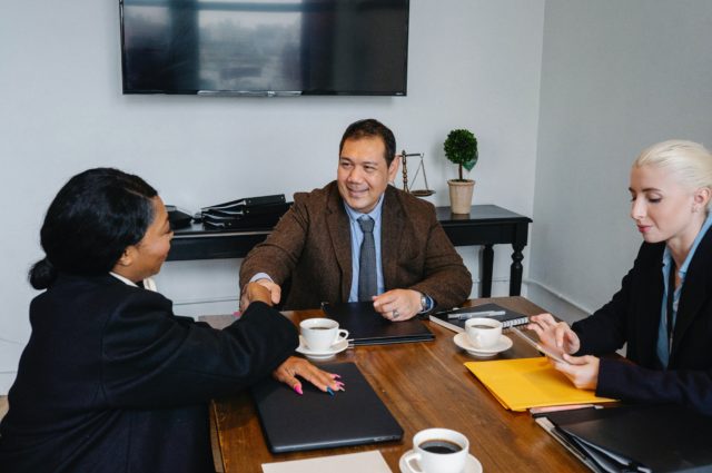 Mediator shaking hands with party experiencing problems and challenges for mediators