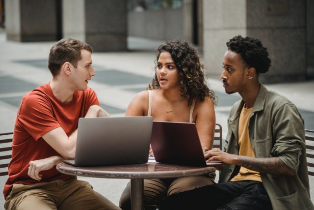 Diverse group of employees talking representing In addition to the legal parameters established to ensure this, employers and leaders are also responsible for effectively addressing and preventing cross cultural conflict in the workplace