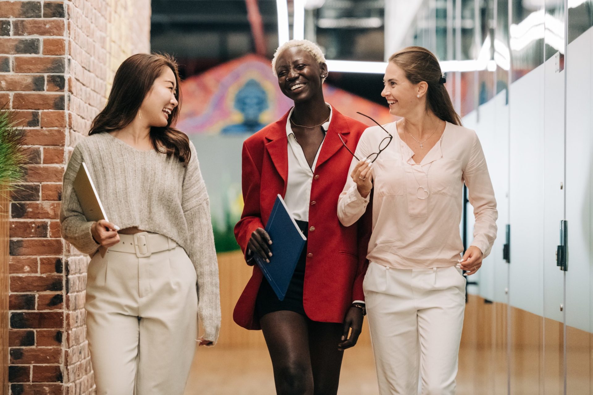 Three coworkers walking together after working through organizational conflict