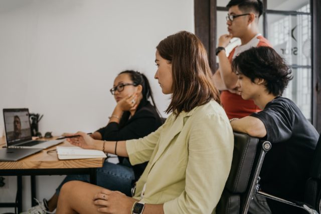 Group of employees gathered by computer in Interventions in Organizations