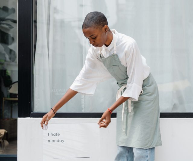 employee putting out a Monday blues sign saying "I hate Mondays"