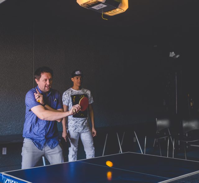 Two men play game of ping pong