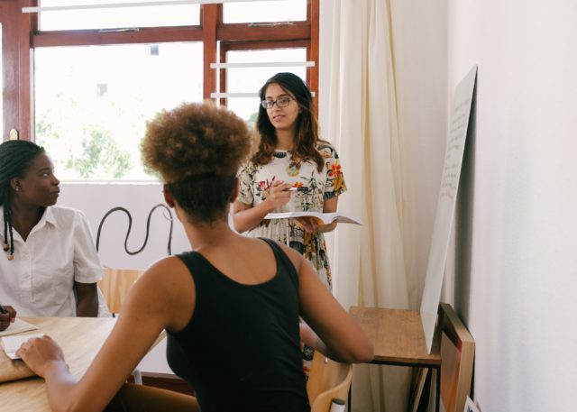 Coworkers collaborating in meeting showing the benefit of intergroup relational identity