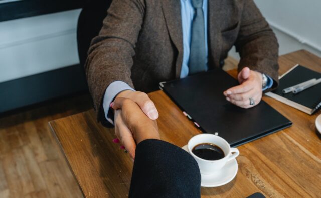 Photo of Two Men Shaking Hands