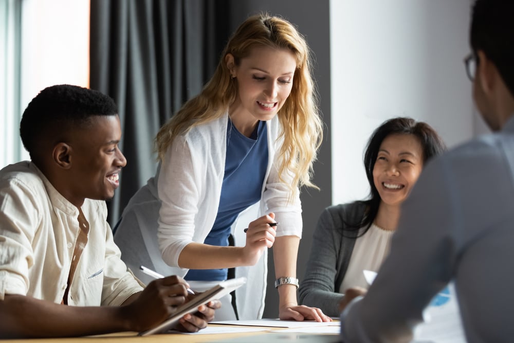 A team member explaining something to other employees