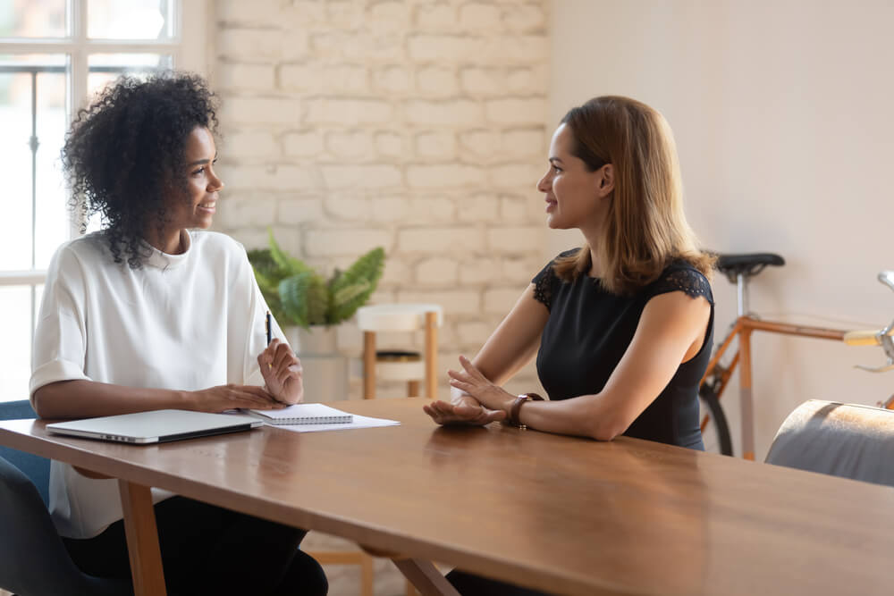 Two female business owners engaging in a calm conversation