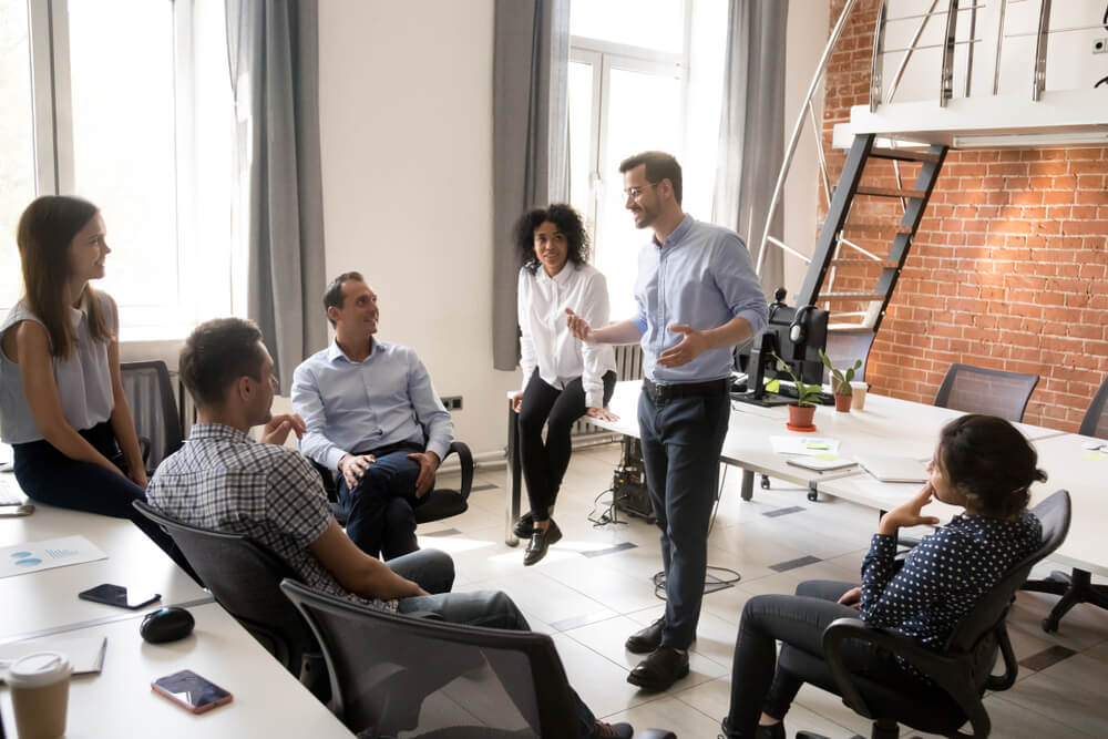 Confident and happy man leading a business meeting