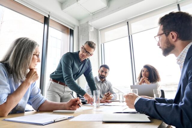 Businessman leader discussing project with diverse coworkers team