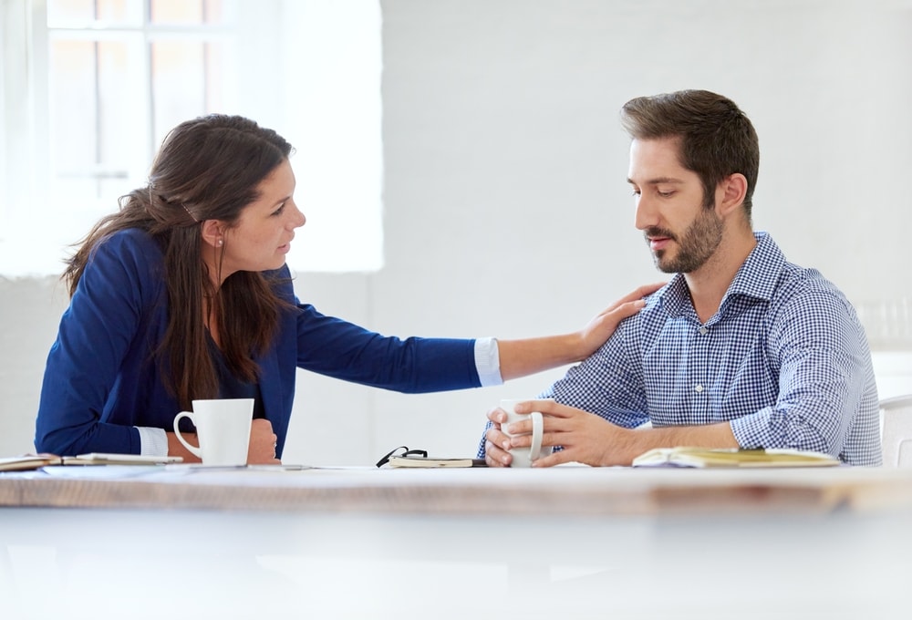 Cropped shot of a young businesswoman consoling her colleague over lunch