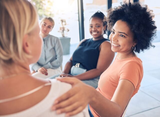 A team of women talking and collaborating at a team building event.