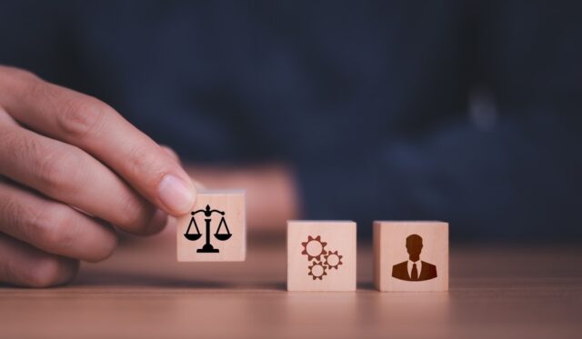 Person putting building block on a table depicting conflict transformation