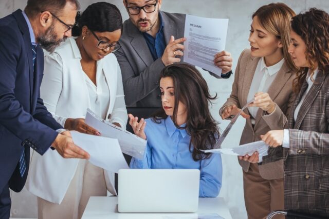 Shot of a young businesswoman looking anxious in a demanding office environment. Frustrated millennial female worker felling tired of working quarreling. Workplace Conflicts.