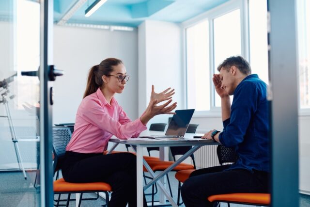 A furious business director of a startup office berating her employee for business mistakes and errors