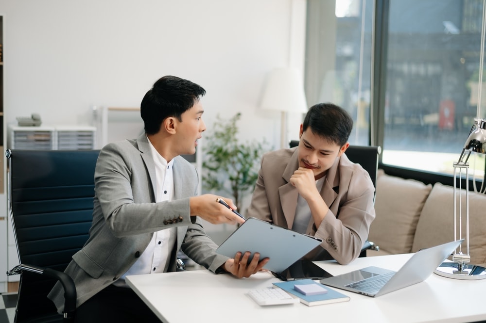 Two male employees arguing over performance evaluation