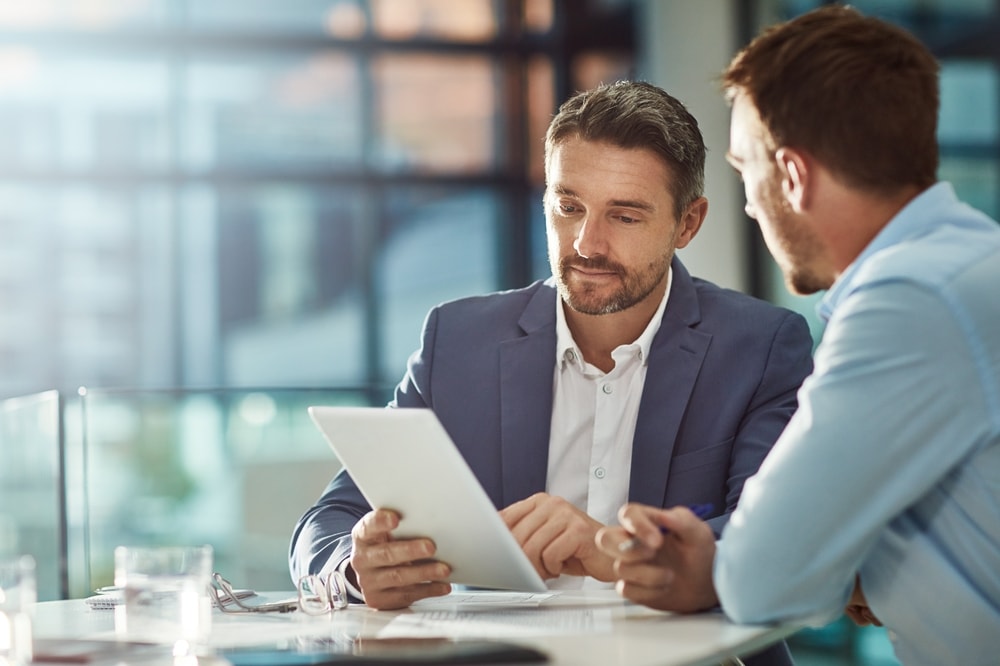 Two business partners collaborating on a project brief