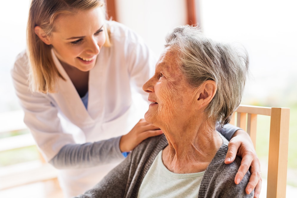 Young woman caring for an elderly woman