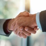 Meeting, handshake and business people in office for deal, welcome or onboarding for b2b collaboration. Partnership, teamwork and shaking hands for agreement, consulting or introduction with trust