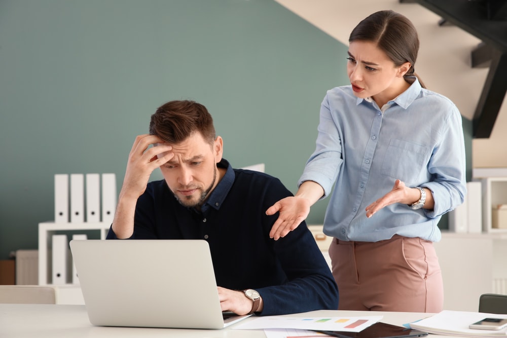 Office employees having argument at workplace