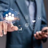 Human Resources management concept. Businessman touch HR icons on virtual screen for recruitment process to work efficiently. training, conflict resolution and promoting corporate culture.