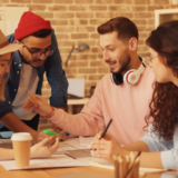 Team collaborating around a table during a planning session to align on goals and direction