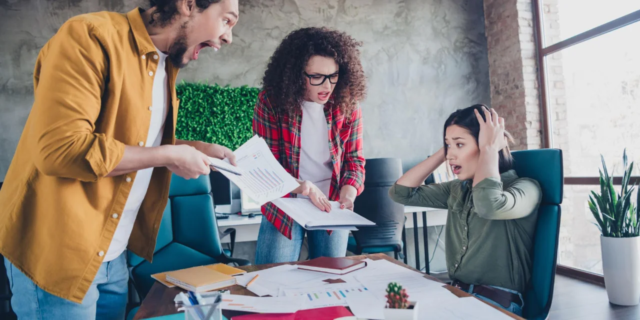 HR professional facilitating a conversation between employees during a workplace conflict