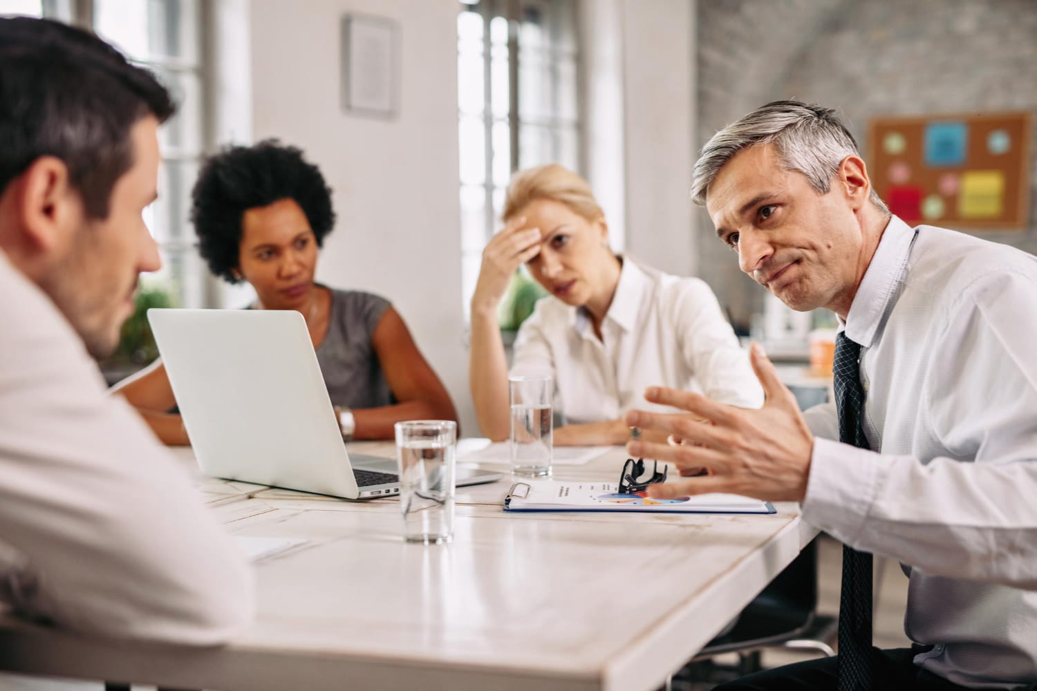 Conflict Resolution for Construction Companies Neutral mediator guiding a conversation between a contractor and subcontractor