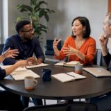 Diverse team engaged in organizational dialogue at conference table